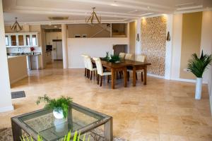 a dining room and kitchen with a table and chairs at La Cresta in Kingstown