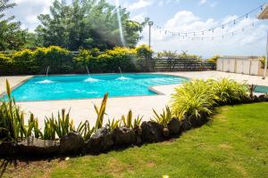 a swimming pool with a fountain in a yard at La Cresta in Kingstown