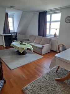 a living room with a couch and a table at Wohnen mitten auf dem Marktplatz mit Parkplatz in Biberach an der Riß
