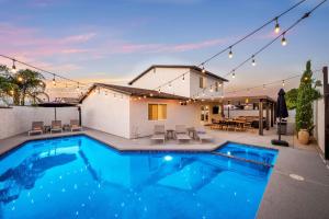 a swimming pool in front of a house at Hidden Gem Retreat With Large Entertainers Backyard in Indio