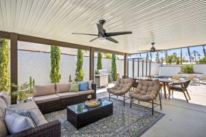 a patio with a couch and chairs and a table at Hidden Gem Retreat With Large Entertainers Backyard in Indio
