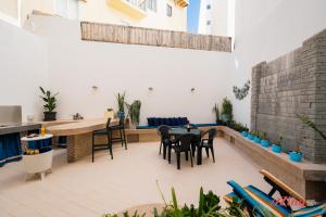 a patio with a table and chairs in a building at The Holiday Home Where Art Lives in St Paul's Bay