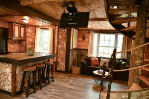 uma sala de estar com um bar numa cabana em Treehouse in Maine woods- The Grand Oak em North Lovell