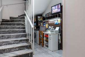 a stairway leading up to a room with ansics at Lefteris Apartment in Kardamaina