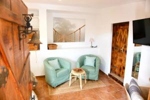 a living room with two chairs and a table at Vila Sitges, big house with pool in Sitges
