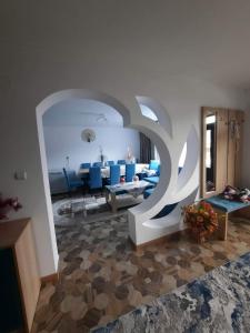 a living room with blue chairs and a couch at Cabana Cosmina &Milan in Cîmpeni