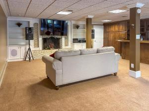 a living room with a couch and a fireplace at Southern Home and fishing lake. in Gainesville