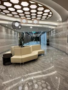 a lobby with a couch in a building at Sentral Luxury Suites KL in Kuala Lumpur