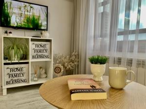 um livro sentado numa mesa de centro numa sala de estar em Snowflake home - Private apartment em Bansko