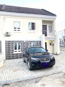 a black car parked in front of a house at CHRIS SPORSHE in Abuja