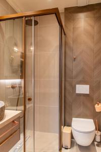 a bathroom with a toilet and a glass shower at Central Kifissia ÁPPεROL Malomar Homing in Athens