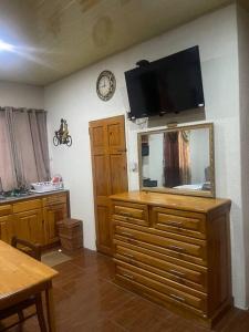 a living room with a mirror and a tv on the wall at BMB Apartment in Georgetown