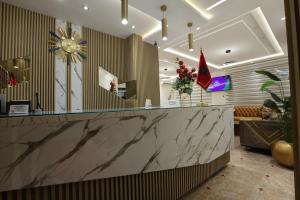 a lobby with a large marble counter in a room at Hôtel Des Lilas in Oujda