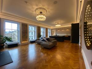 a living room with a couch and a table at Ashton View in Glasgow