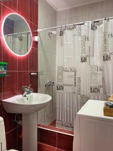a bathroom with a sink and a shower curtain at MDM House in Sutomore