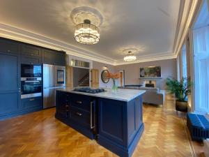 a kitchen with a blue island in a living room at Ashton View in Glasgow