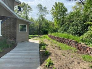 a house with a walkway next to a brick wall at The Freedom House by Patriot Properties in Wisconsin Dells