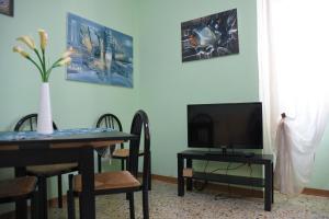 a dining room with a table and a television at La Fontana in Spoleto