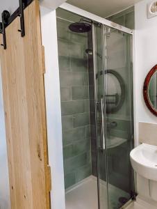 a shower with a glass door in a bathroom at Priory Cottage Stables in Cowden