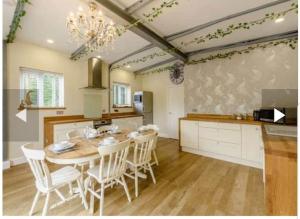 a kitchen with a table and chairs in a room at Lillibelles lodge,Oak tree farm in Ashford