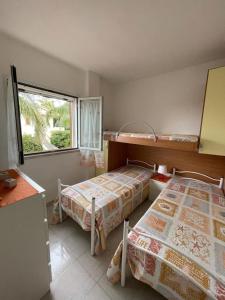 En eller flere senge i et værelse på Casavacanzekastalia