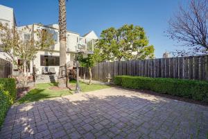 a house with a fence and a brick driveway at San Francisco Home with Hot Tub about 2 Mi to Downtown! in San Francisco