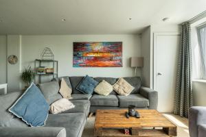 a living room with a couch and a table at CoHost Partners- Warm Retreat in Bristol Heart in Bristol