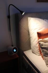 a lamp sitting on a night stand next to a bed at penthouse-studio centrally located in Zurich in Zürich