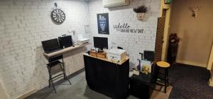 a bar in a room with a white brick wall at One Avenue Hotel Balakong in Seri Kembangan