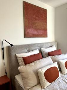 a bed with a bunch of pillows on it at penthouse-studio centrally located in Zurich in Zurich