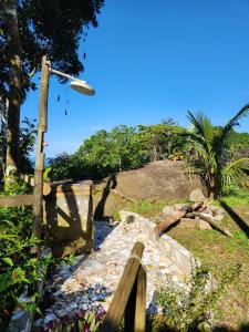 a stone path with a street light on a hill at Hospedagem Casa Maracujá in Trindade