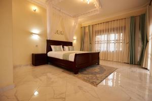 a large bedroom with a bed and a large window at The Forest House - Kawuku-Bunga in Kampala