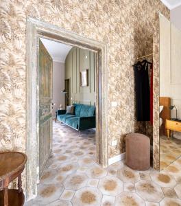 a living room with a blue couch and a mirror at Ziolì in Noto