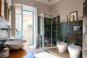 a bathroom with a shower and a sink and a toilet at Ziolì in Noto