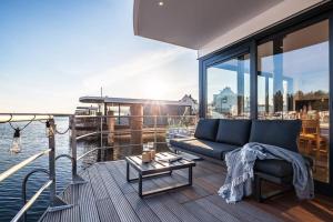 a living room with a couch and a table on a boat at Hausboot Chalet am Meer - LP8 in Peenemünde