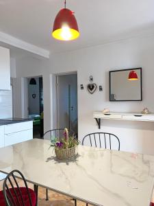 a dining room with a white table and chairs at MDM House in Sutomore