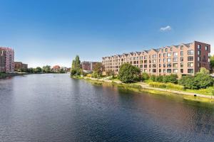 a view of a river in a city with buildings at Rezydencja Wintera 3 by Grand Apartements in Gdańsk