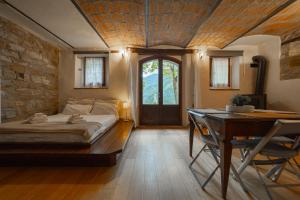 a bedroom with a bed and a desk and a table at Borgo Pianello Country Resort in Lizzano in Belvedere