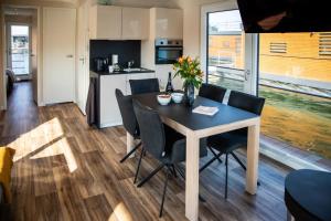 a kitchen and dining room with a table and chairs at Hausboot Bellini in Klitten