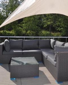 a couch sitting under a tent on a deck at Hausboot Aquamarin - LP4 in Höxter