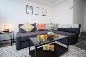 a living room with a couch and a table at Cardiff Getaway | City Center | Free Parking in Cardiff