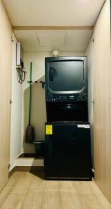 a television sitting on top of a refrigerator in a room at New luxury and comfort apartment, fully furnished in Monterrey Centro. (Includes: Pool, Parking lot, A.C., WiFi, Gym) in Monterrey