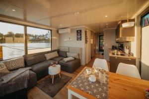 a living room with a couch and a table at Hausboot Enola in Fürstenberg-Havel