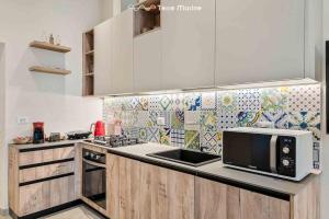 a kitchen with a microwave on a counter top at La Frida, Terre Marine in Lerici