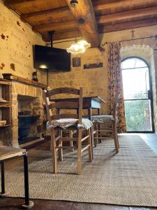 a dining room with a table and a chair and a tv at Alloggio La Torre Fossanova in Priverno