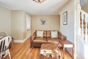 un soggiorno con divano in pelle marrone di Host & Stay - Snoozy Goose a Ovingham