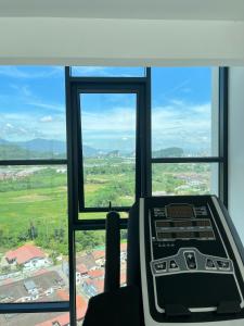 a room with a window with a view of a city at The Horizon Ipoh By Iconique Espace in Ipoh