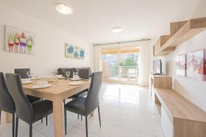 jadalnia z drewnianym stołem i krzesłami w obiekcie Apartamento Zeus - PlusHolidays w mieście Calpe