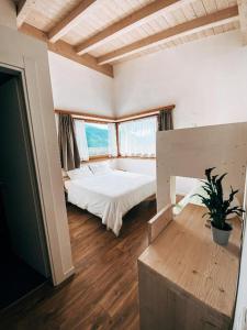 a large bedroom with a bed and a large window at AGRITURISMO DAL PEROTIN in Caldonazzo