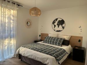 a bedroom with a bed and a globe on the wall at ARC EN CIEL B&B in Pontorson